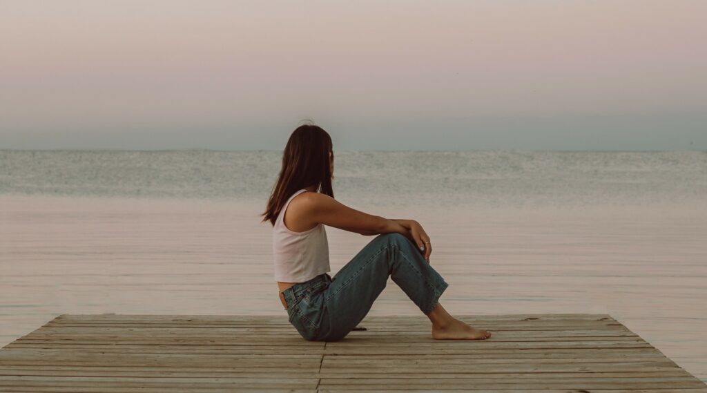 woman breathing overlooking ocean